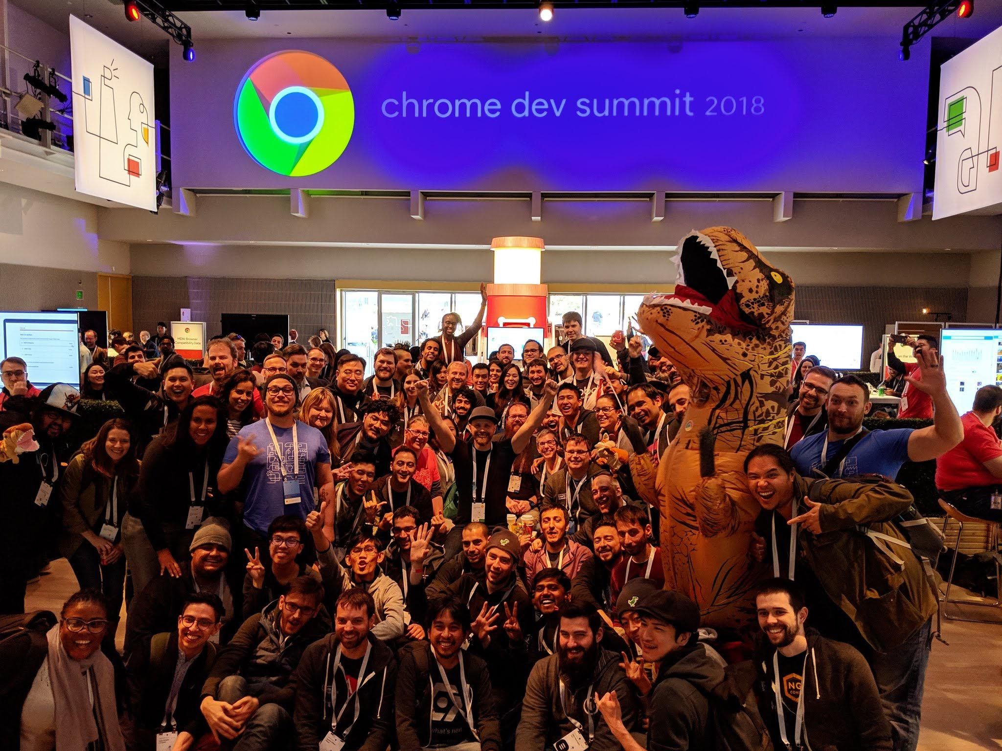 Group photo of attendees at Chrome Dev Summit with a person in a dinosaur costume